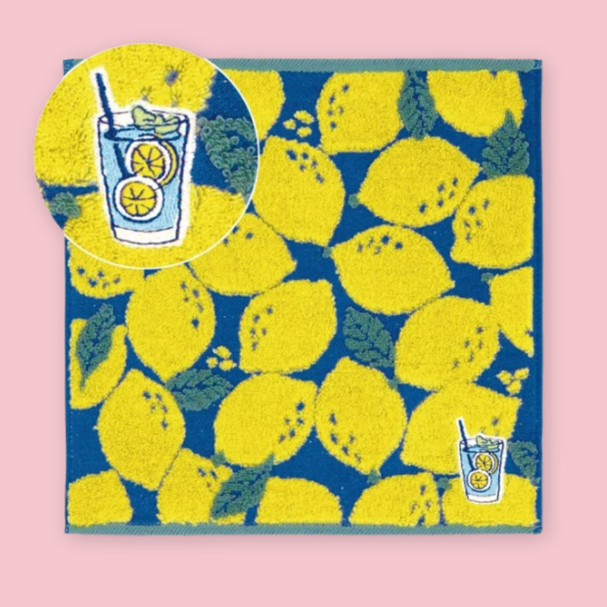 Imabari mini towel with bright yellow lemons and a lemon drink design on a blue background.