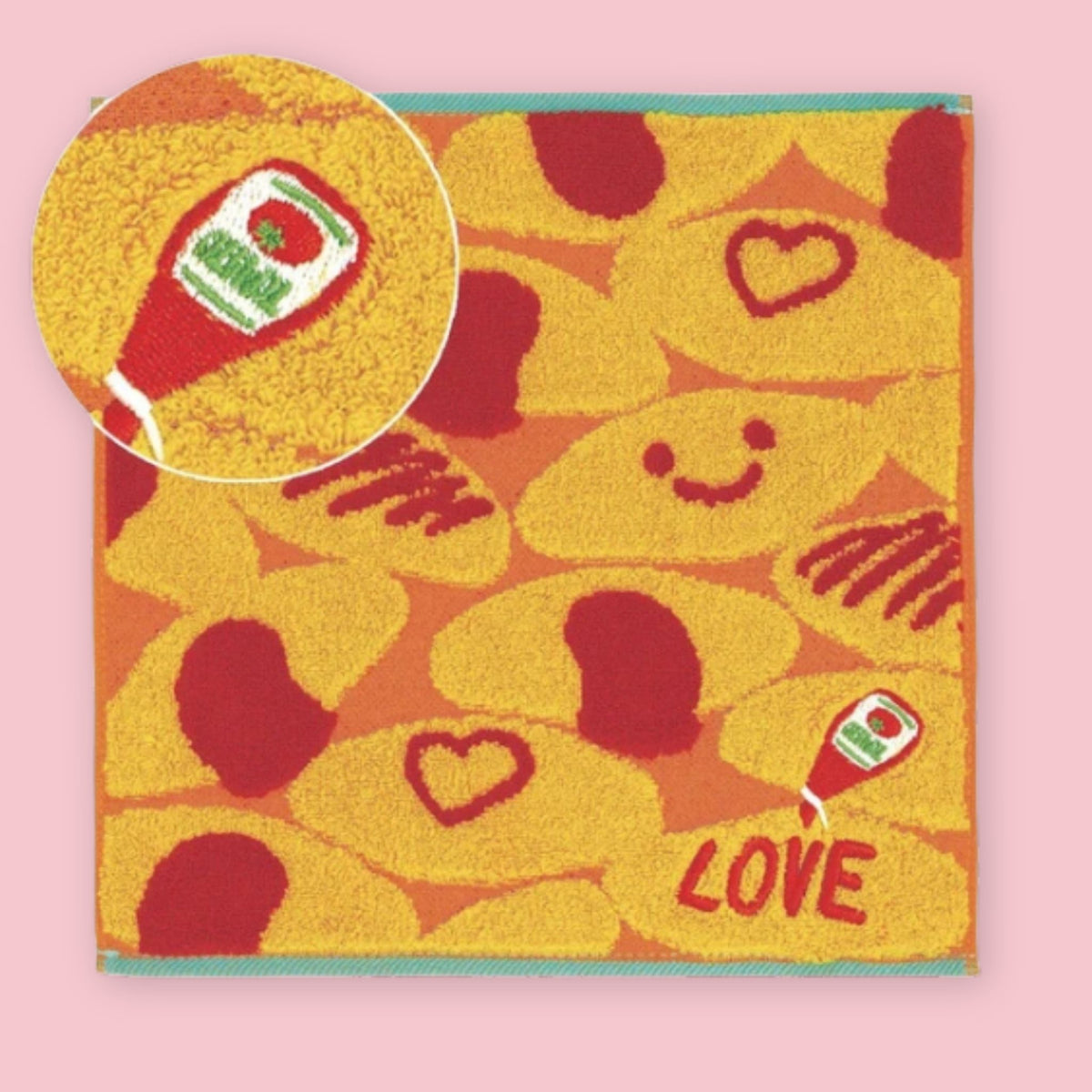 Imabari mini towel with colorful omurice, ketchup, and heart design on a pink background.