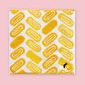 Imabari mini towel with yellow Japanese rolled omelette pattern on a white background.