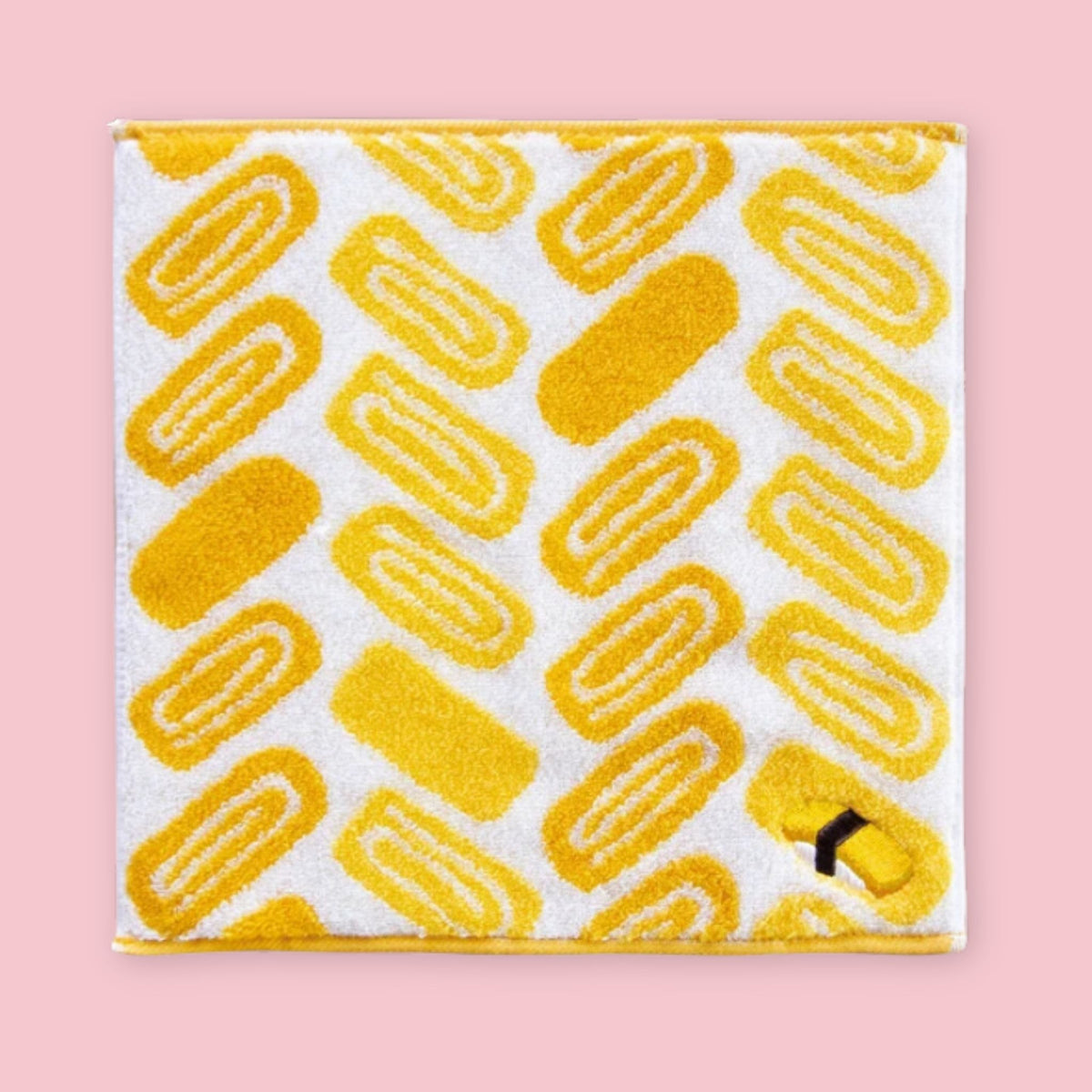 Imabari mini towel with yellow Japanese rolled omelette pattern on a white background.