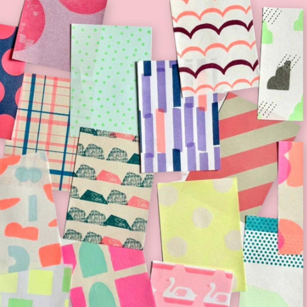 Close-up of assorted neon patterned loose sheets from the Iro Iro Memo Pad spread out on a pink background