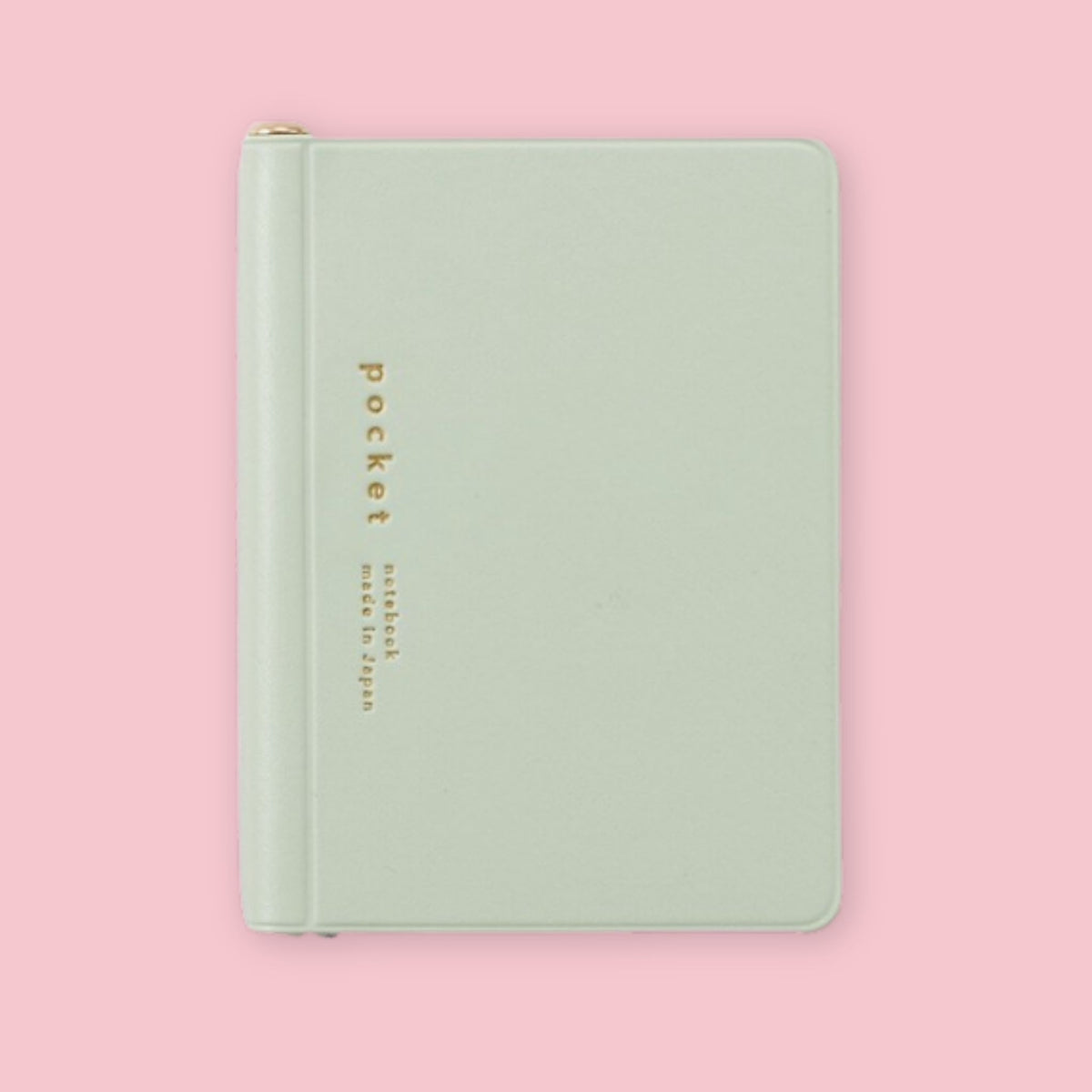 Light green Daigo Isshoni Pocket Notebook with gold lettering on a pink background.