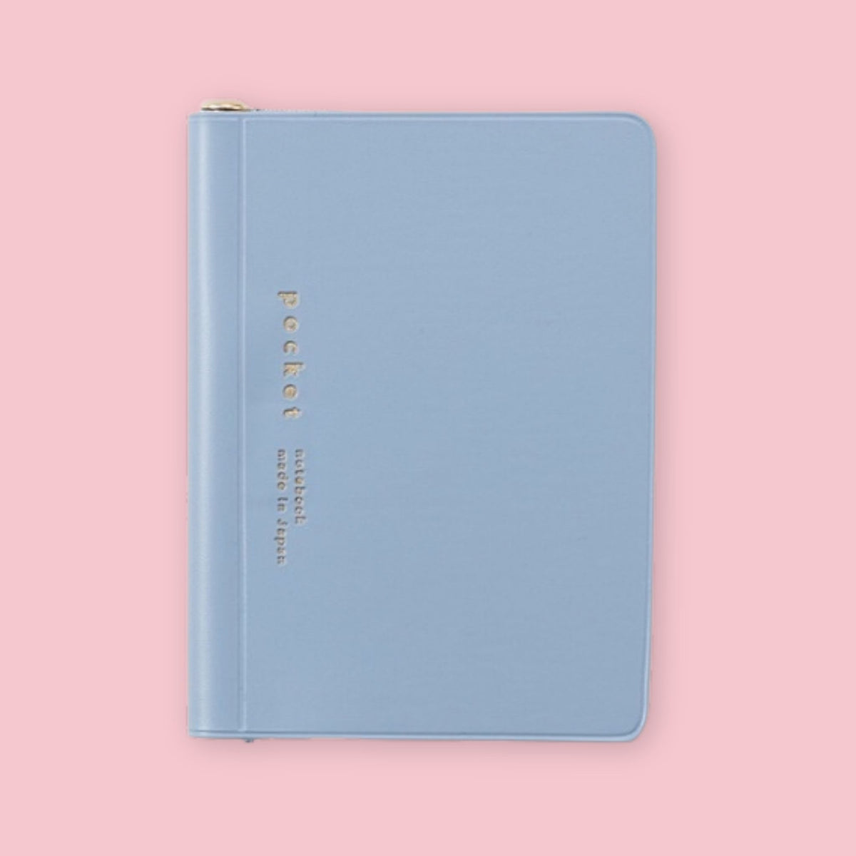 Blue Daigo Isshoni Pocket Notebook with gold lettering on a pink background.