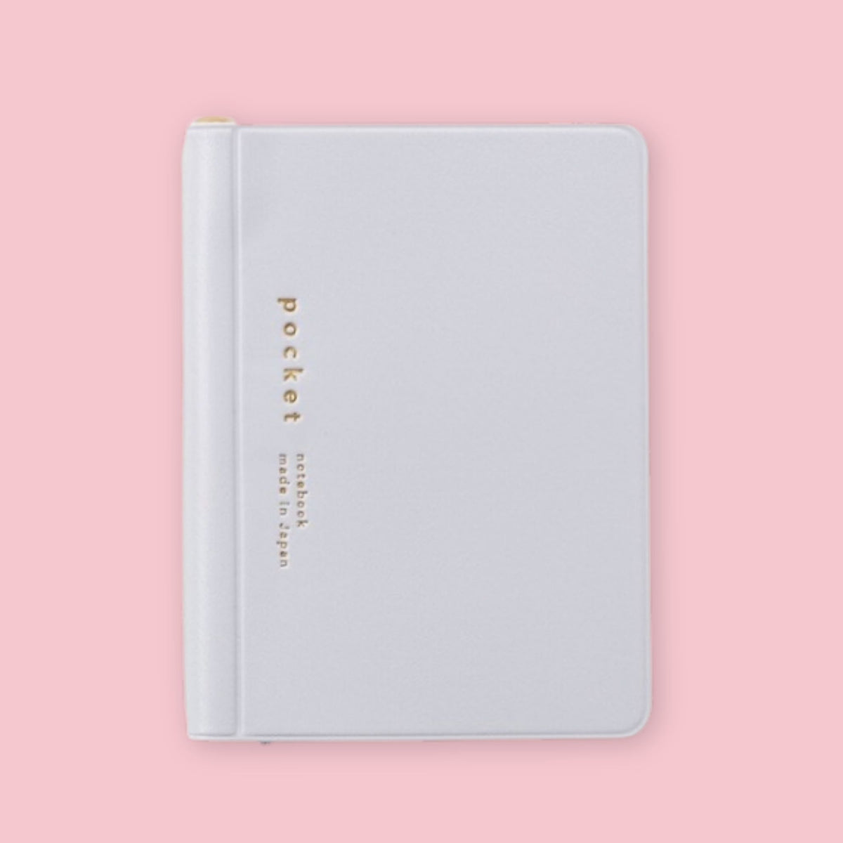Grey Daigo Isshoni Pocket Notebook with gold lettering on a pink background.