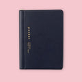 Black Daigo Isshoni Pocket Notebook with gold lettering on a pink background.