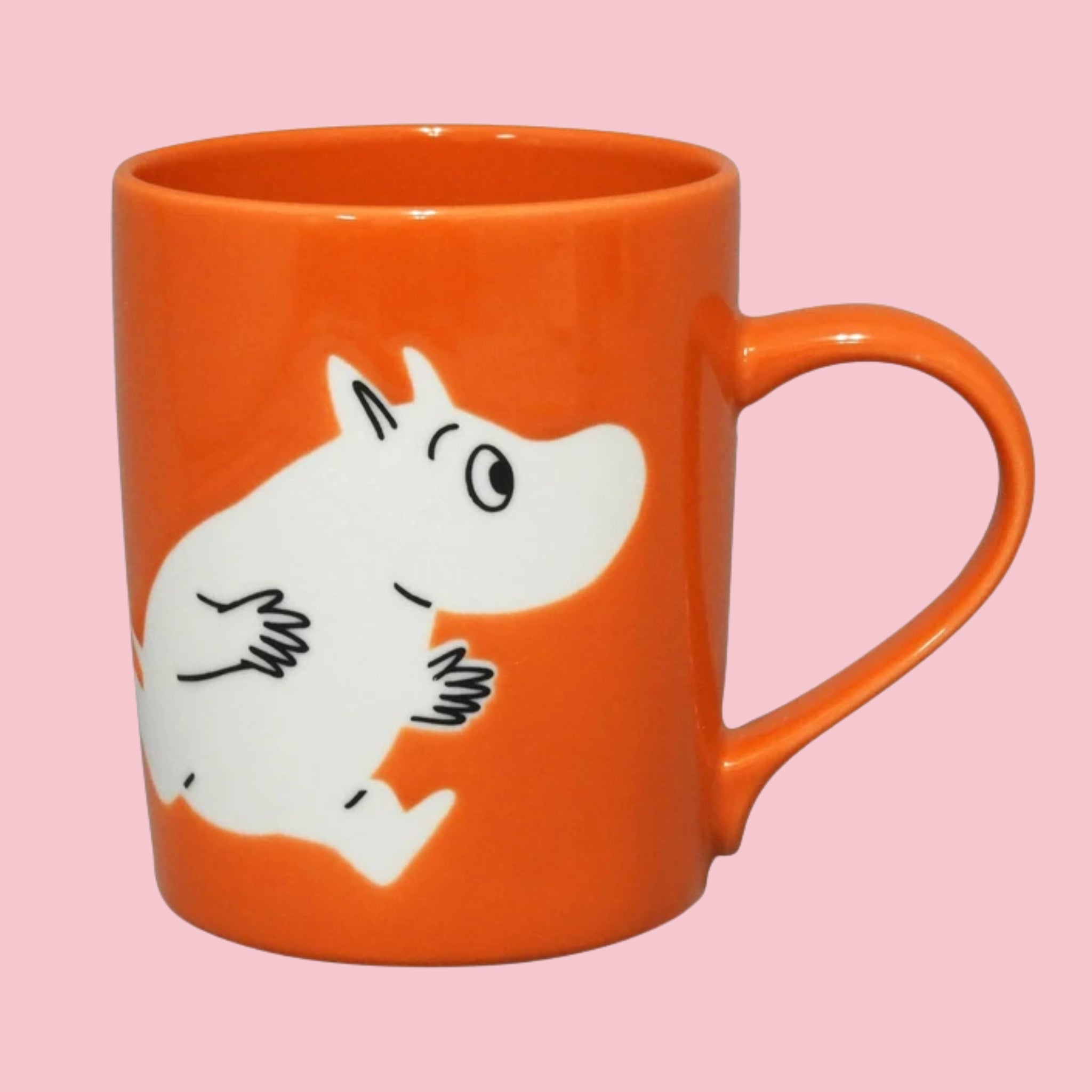 Red-orange Japanese Moomin mug with an embossed Moomin in a classic running pose, on a pink background