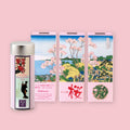 Jugetsudo Sakura Sencha tin and packaging featuring Hokusai woodblock print artwork on a pink background