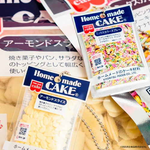 Miniature Home Made Cake charms featuring Japanese almond slice and colorful sprinkle packages, shown with ball chains among matching baking-supply packaging.