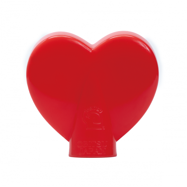 Back view of red heart-shaped Obitsu Kewpie hood doll, showing embossed Obitsu Japan logo on the base.