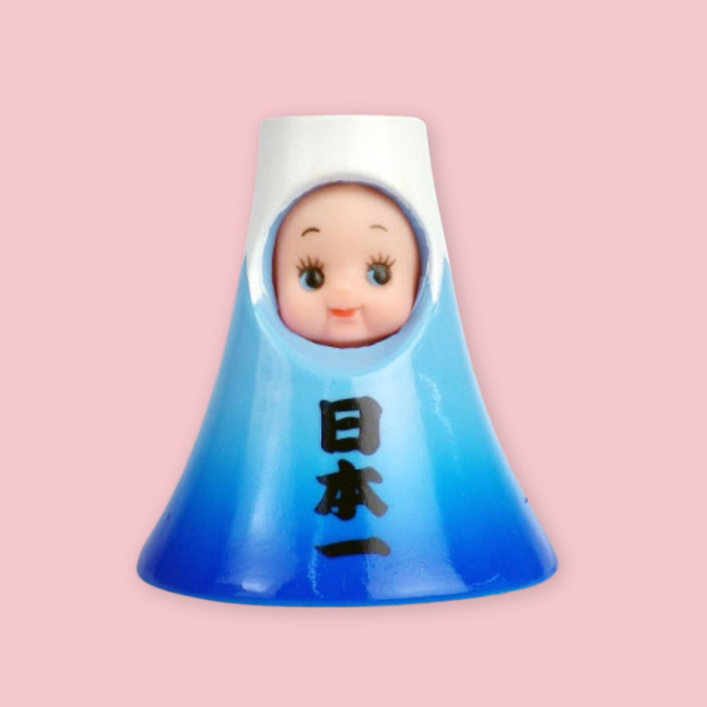 Obitsu Kewpie doll dressed as Mount Fuji, with a blue mountain-shaped hood and Japanese characters on the front.