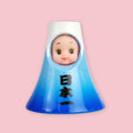Obitsu Kewpie doll dressed as Mount Fuji, with a blue mountain-shaped hood and Japanese characters on the front.