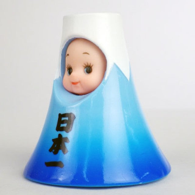 Side view of Obitsu Kewpie doll dressed as Mount Fuji, with a blue mountain-shaped hood and Japanese characters on the front.