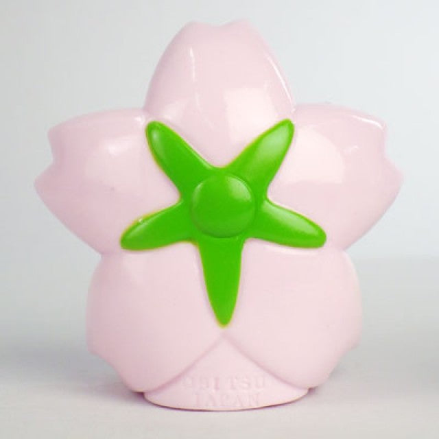 Back view of Obitsu Kewpie cherry blossom hood doll, showing pale pink petals and a green flower center.
