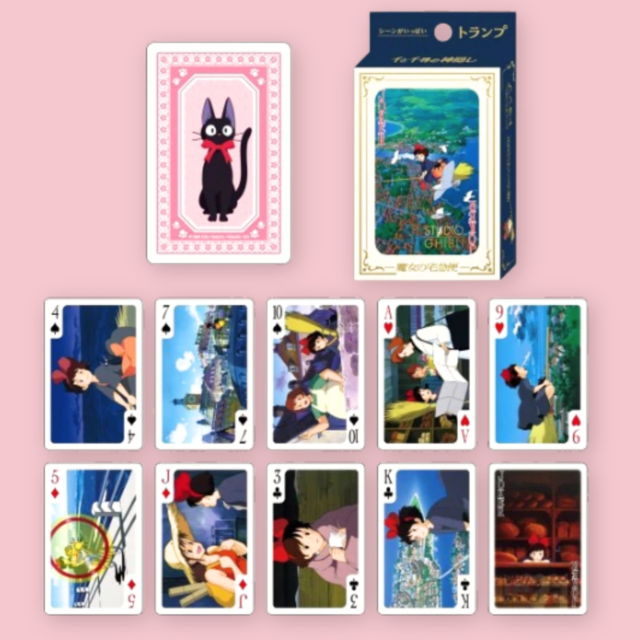 Studio Ghibli Kiki's Delivery Service playing cards with card box and a card back design featuring Jiji the black cat, shown alongside an assortment of face cards illustrated with scenes and characters from the film, against a pink background
