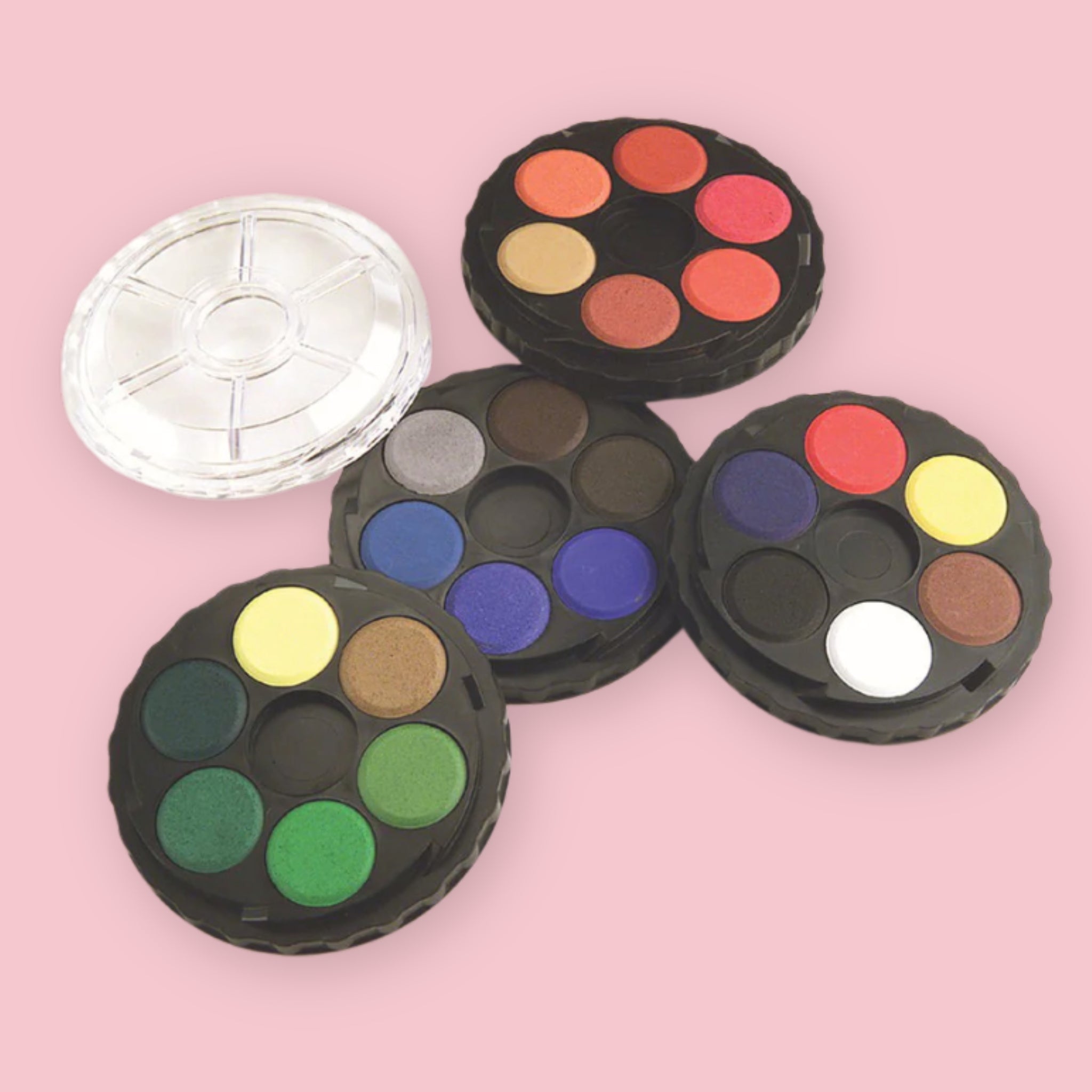 Koh-I-Noor Watercolor Wheel showing four unlocked round trays with 24 opaque watercolor pans and clear mixing lid on a pink background