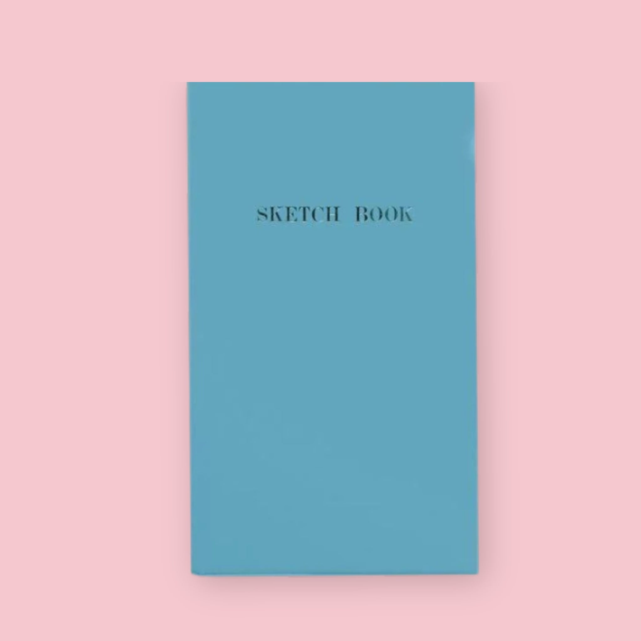 Blue Kokuyo Sketch Book with gold lettering on a pink background