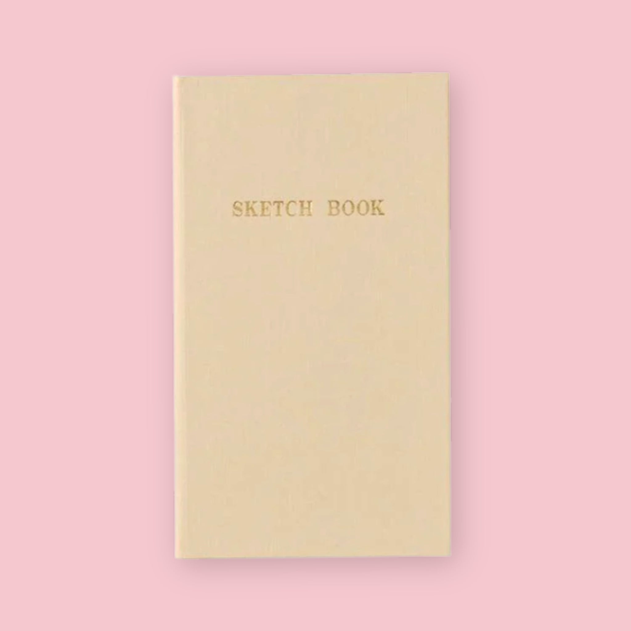 Cream Kokuyo Sketch Book with gold lettering on a pink background