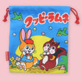 Kuppy Ramune drawstring bag with rabbit and squirrel characters, red cords, candy illustrations, and Japanese logo text.