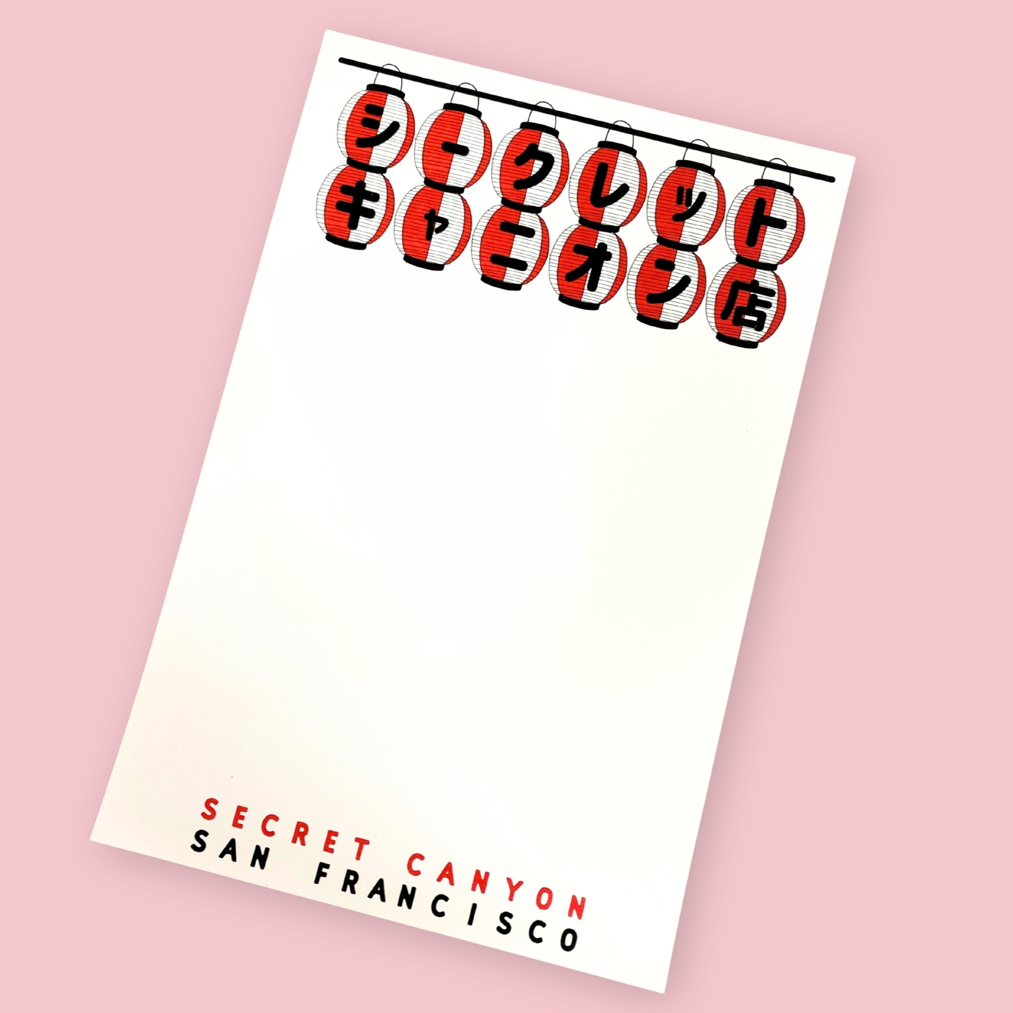 Secret Canyon San Francisco notepad with red Japanese lantern illustration on a pink background