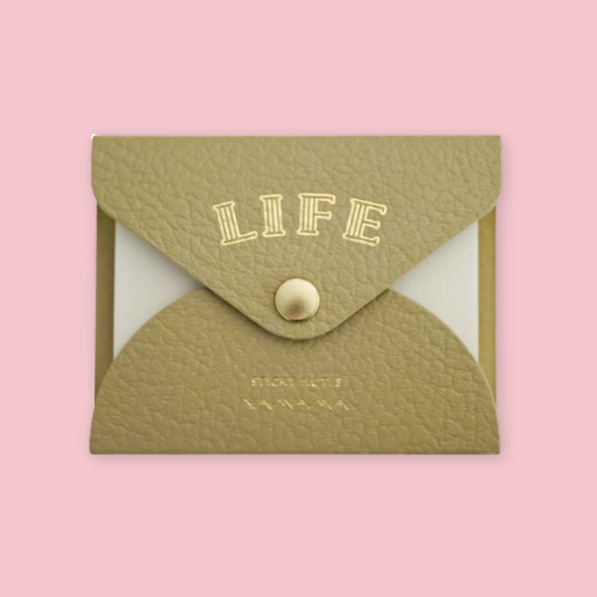 Beige faux leather envelope pouch embossed with "LIFE" sticky notes, snap closure, on a pink background.