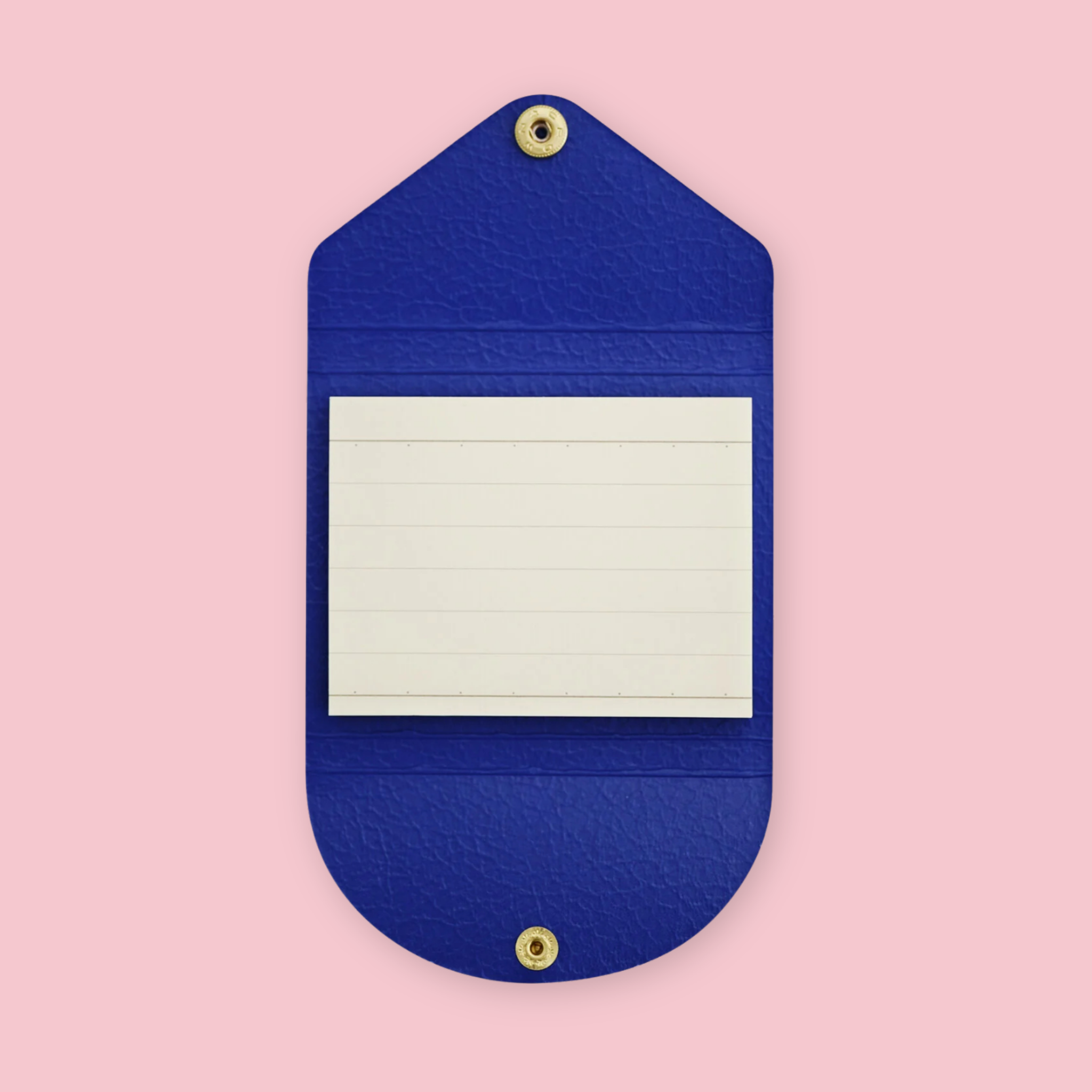 Royal blue faux leather sticky note pouch shaped like an envelope, open to show lined paper notepad inside, snap closures top and bottom, on a pink background