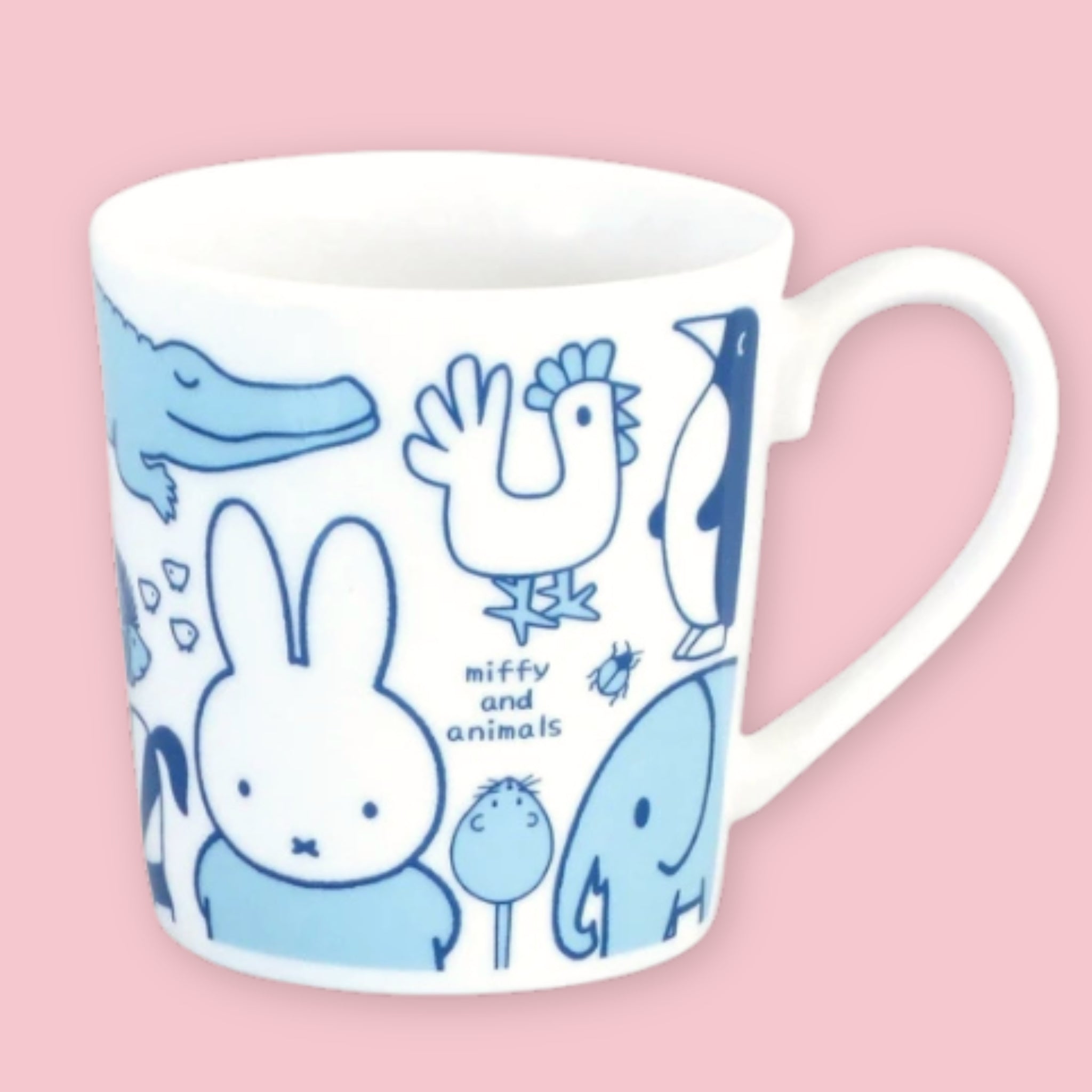 White mug printed with blue "Miffy and Animals" illustrations including Miffy, a crocodile, rooster, penguin, beetle, and elephant, against a pink background