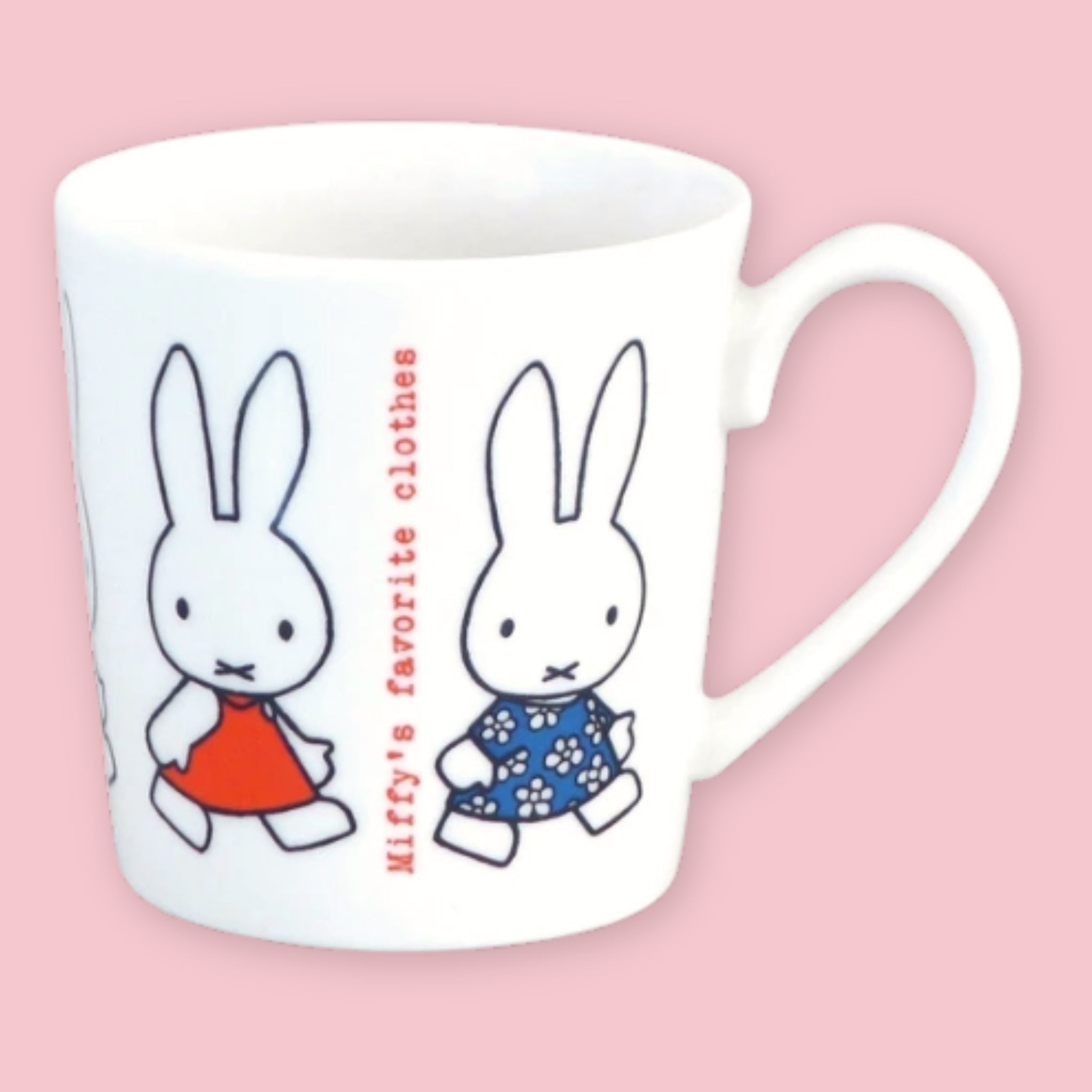 White mug printed with Miffy in a red dress and a friend in a blue floral dress alongside "Miffy's favorite clothes" text, against a pink background