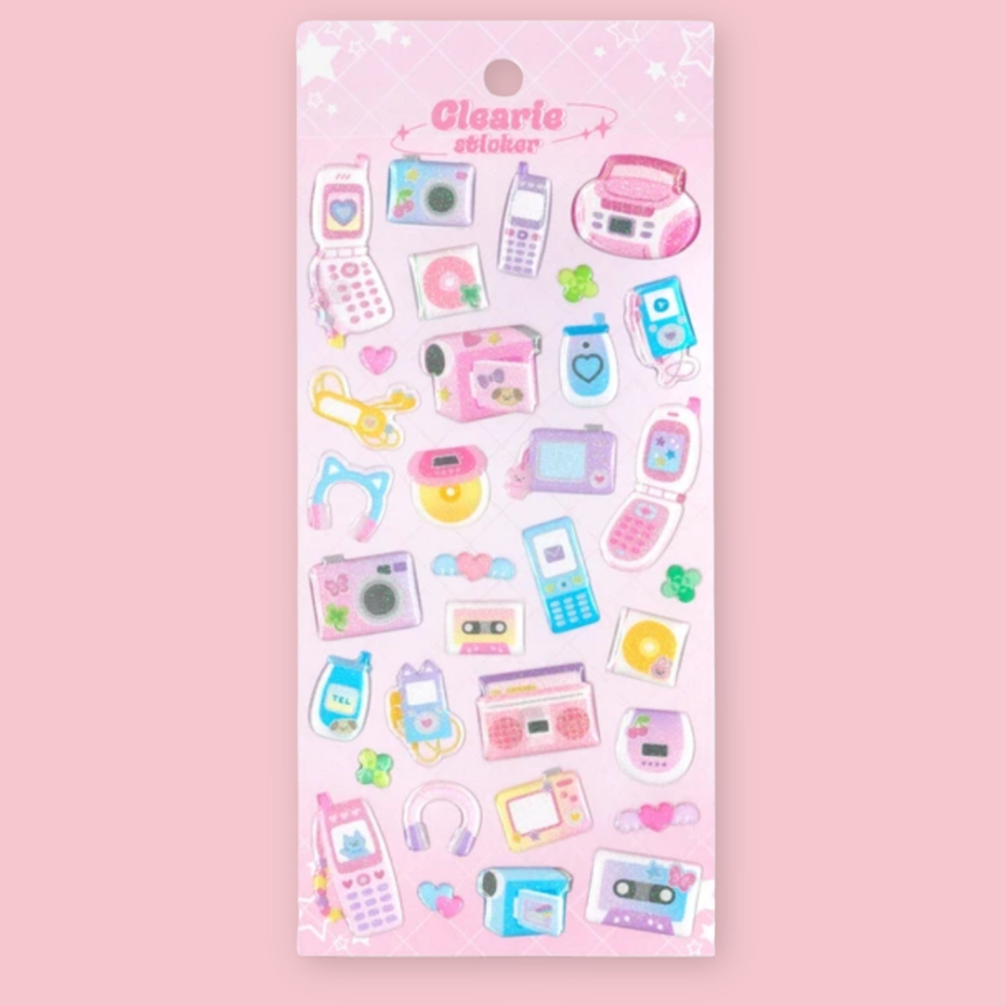 A sheet of pastel-colored stickers featuring retro mobile phones, cameras, cassette tapes, headphones, and hearts, displayed on a pink backing card labeled 'Clearie stickers'.