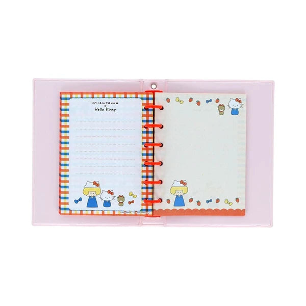 Interior of Mizutama x Hello Kitty sticker album with red rings, plaid pages, and Sanrio character artwork.