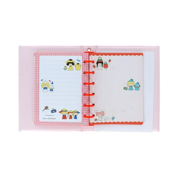 Interior of Mizutama x Sanrio sticker album with red rings, memo-style pages, and colorful character artwork.