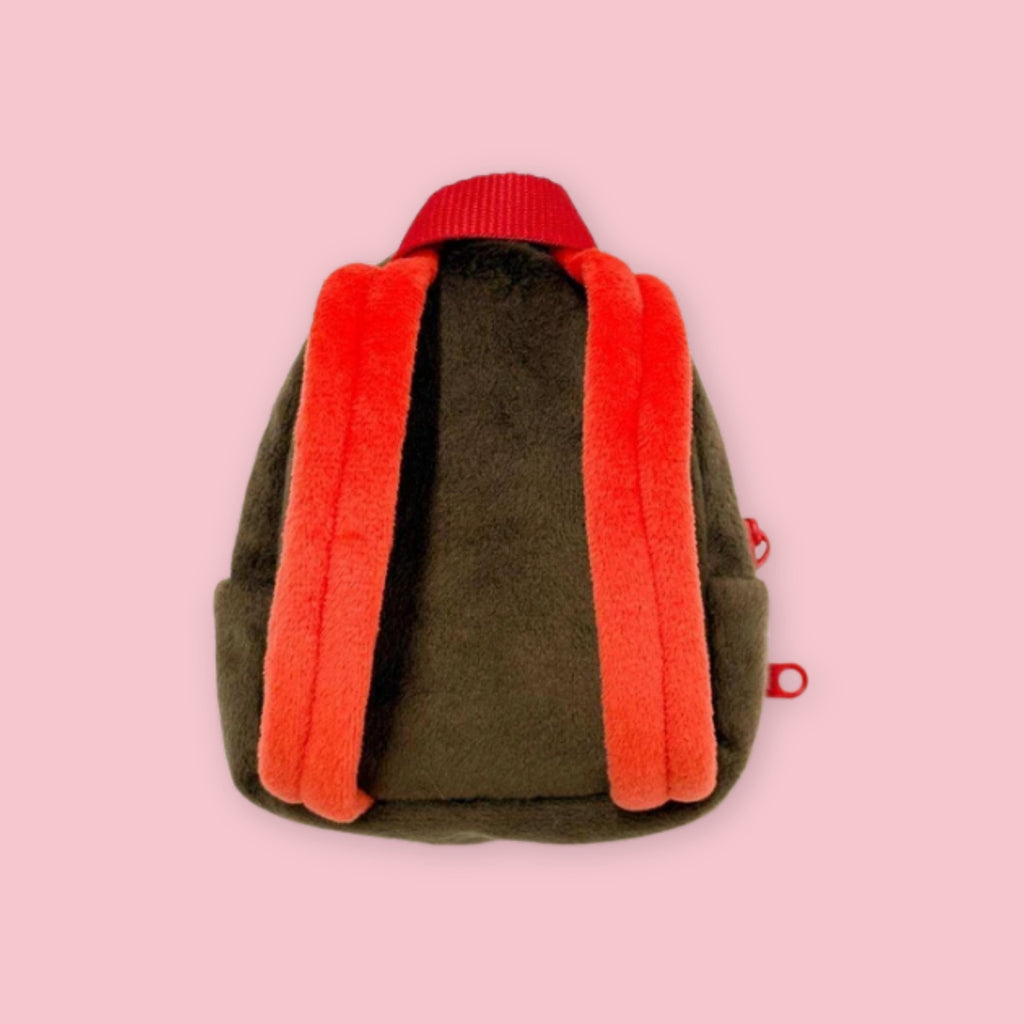 Back view of Monchhichi plush backpack pouch with orange shoulder straps and brown fabric body.