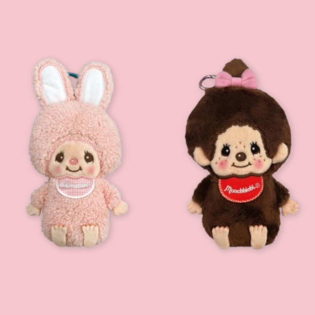 Monchhichi plush body pouches in pink bunny and classic brown styles, shown on a pink background.