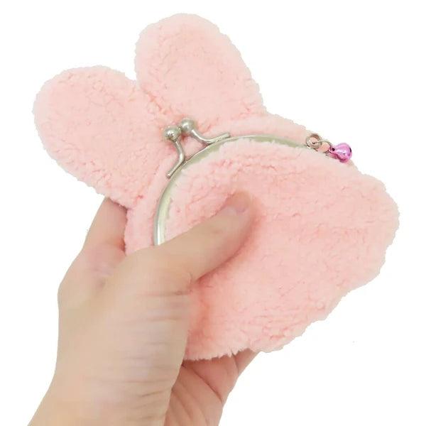 Monchhichi plush coin purse shown from the back, with pink fur, silver clasp, and pink charm on a white background.