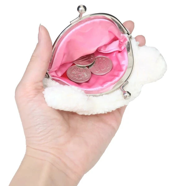 Monchhichi plush coin purse shown open in a hand, with pink satin lining, silver clasp, and coins inside.