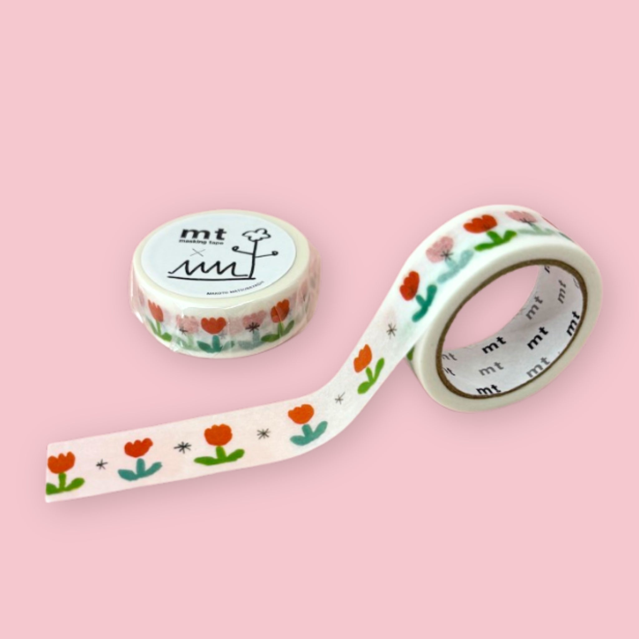 Two rolls of mt x Makoto Matsubayashi washi tape with simple red tulips, green leaves, and small black starbursts on a pastel pink background.