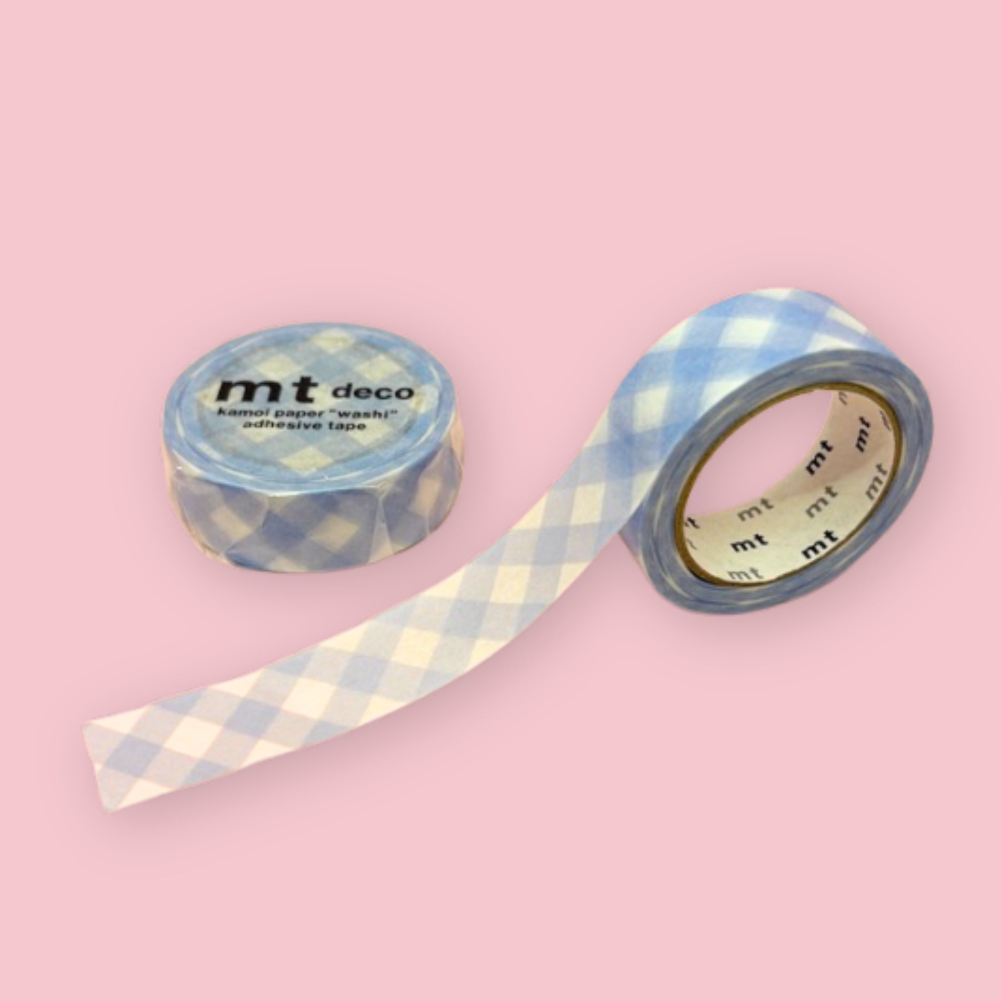 Two rolls of mt deco washi tape with a pastel ultramarine blue gingham check pattern on a white background, photographed on pastel pink.