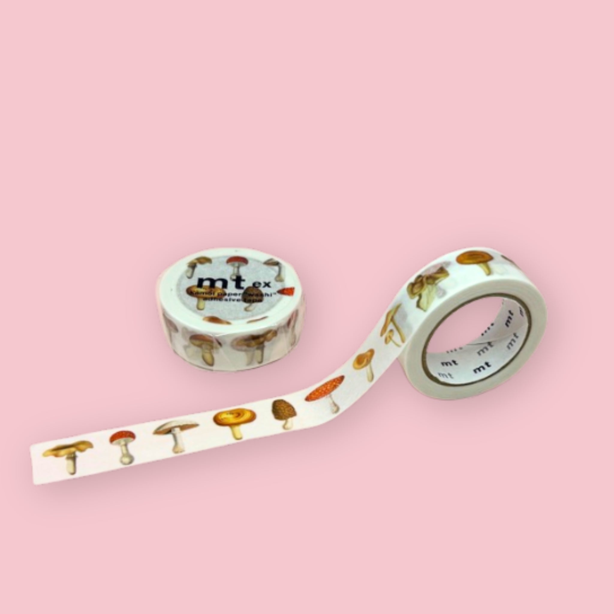 Two rolls of mt ex washi tape with assorted illustrated mushrooms on a white background, photographed on pastel pink.