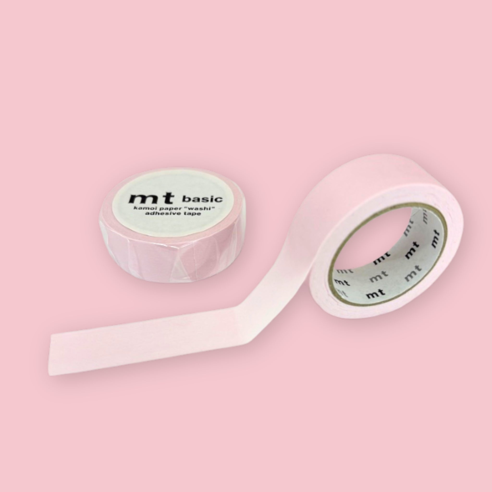 Two rolls of pale pink mt basic washi tape on a pastel pink background.