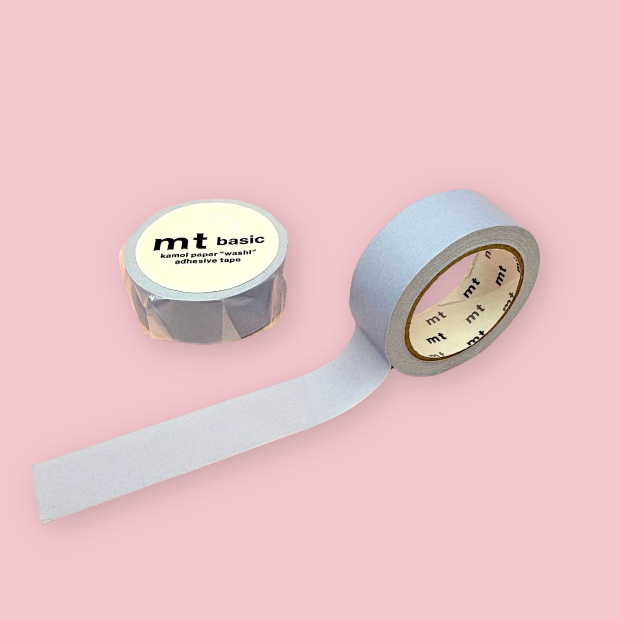 Pastel ultramarine blue mt basic washi tape, shown partly unspooled beside a wrapped roll on a pink background.