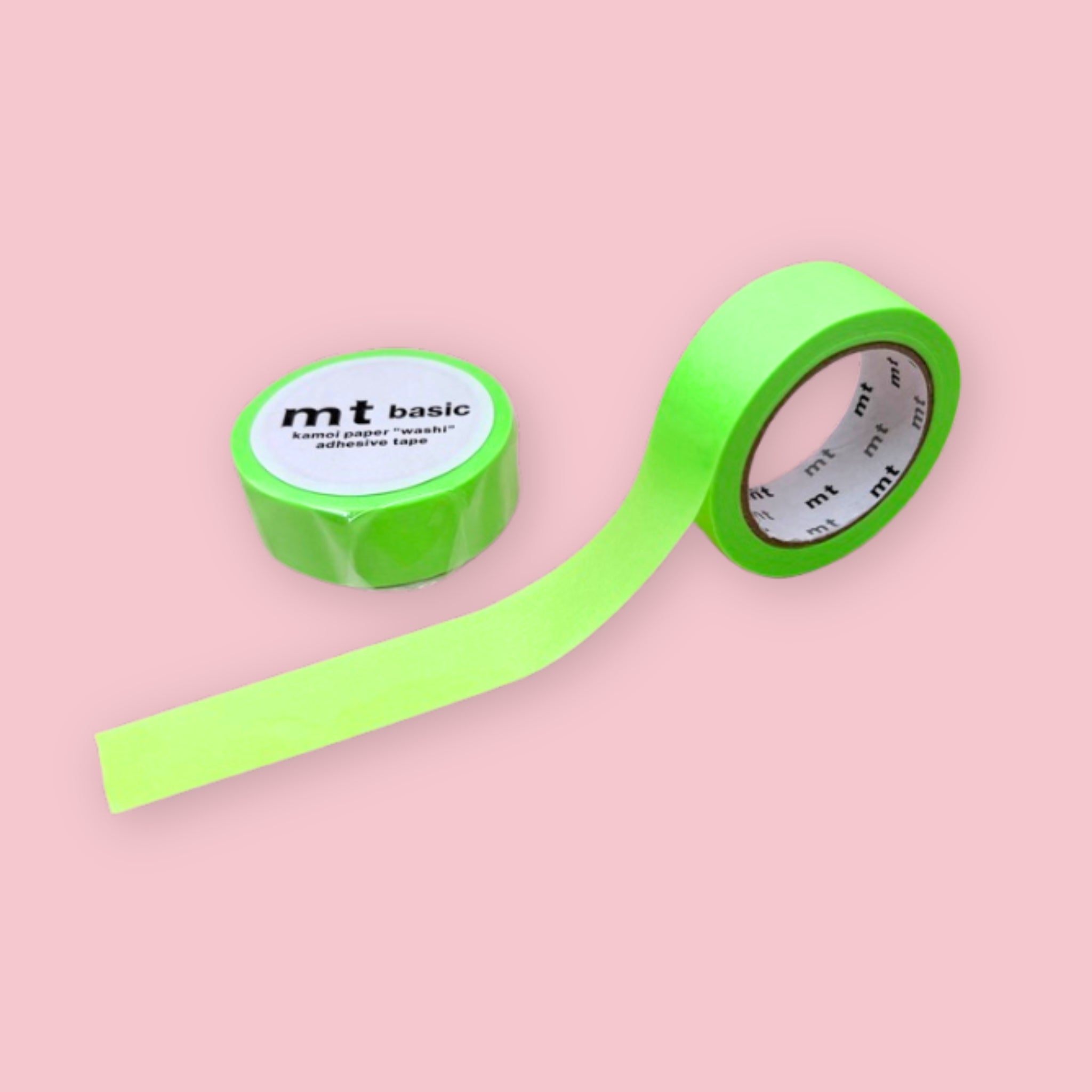 Two rolls of neon green mt basic washi tape on a pastel pink background.