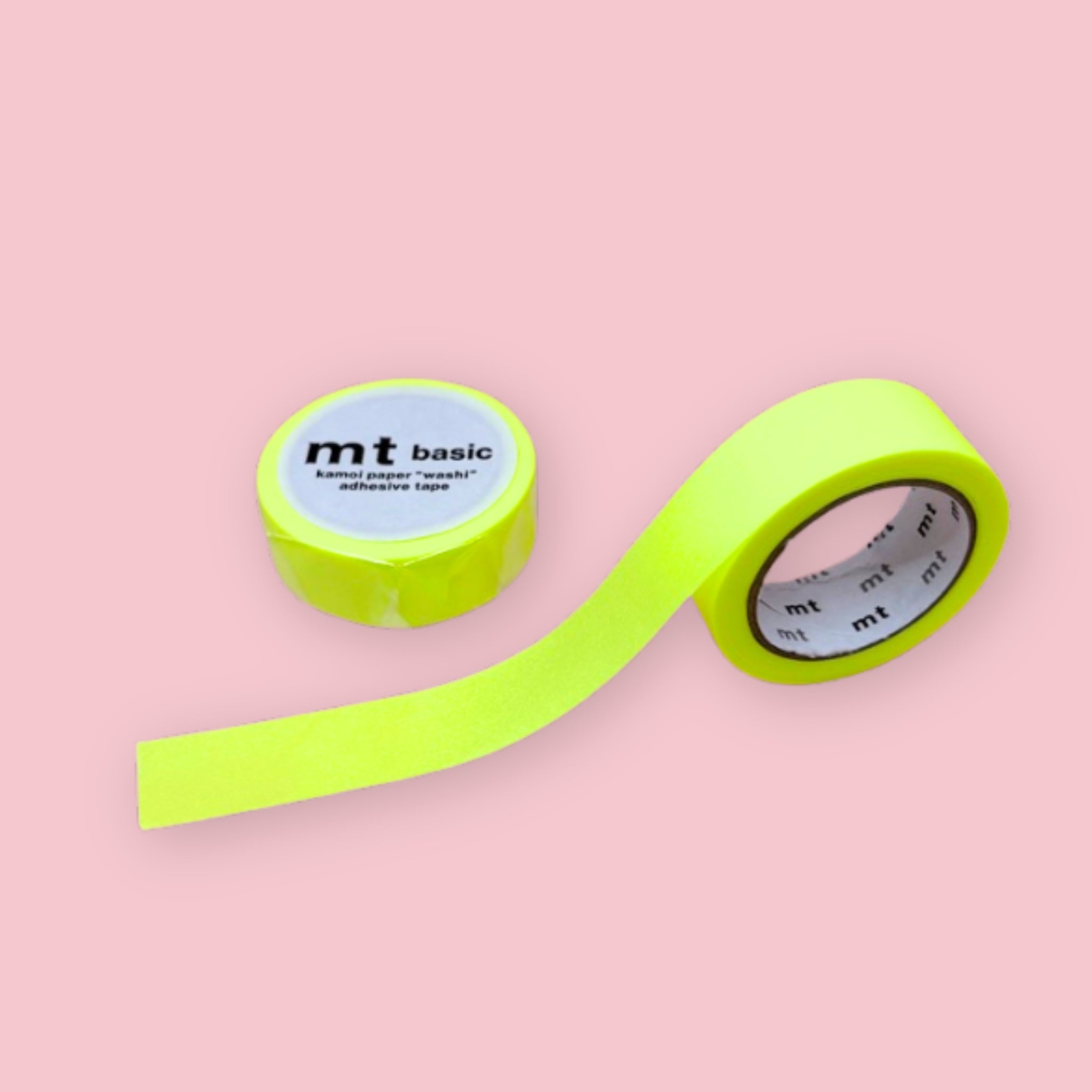 Two rolls of neon yellow mt basic washi tape on a pastel pink background.