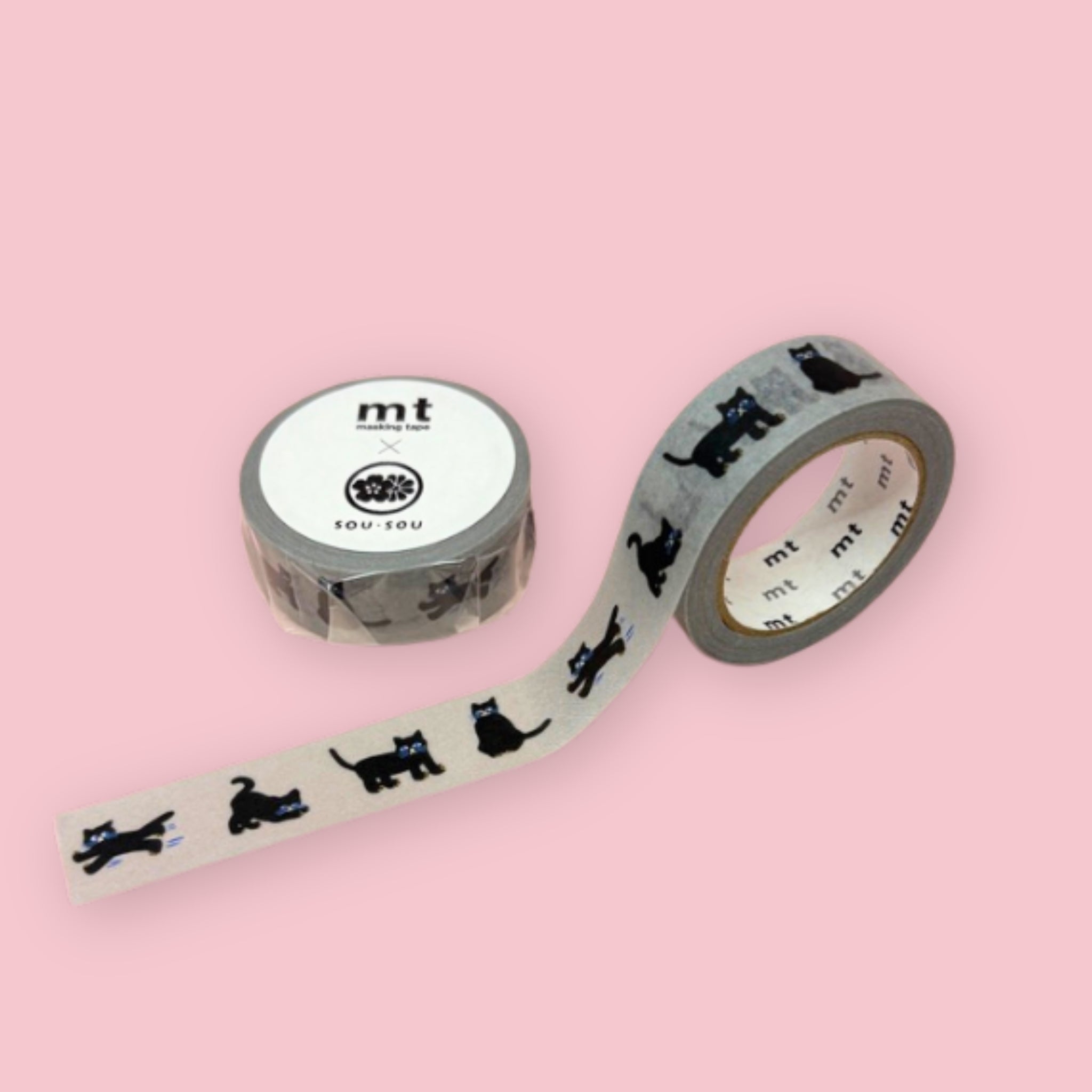 Two rolls of mt x sou sou washi tape with black cat silhouettes and small blue accents on a gray background, photographed on pastel pink.