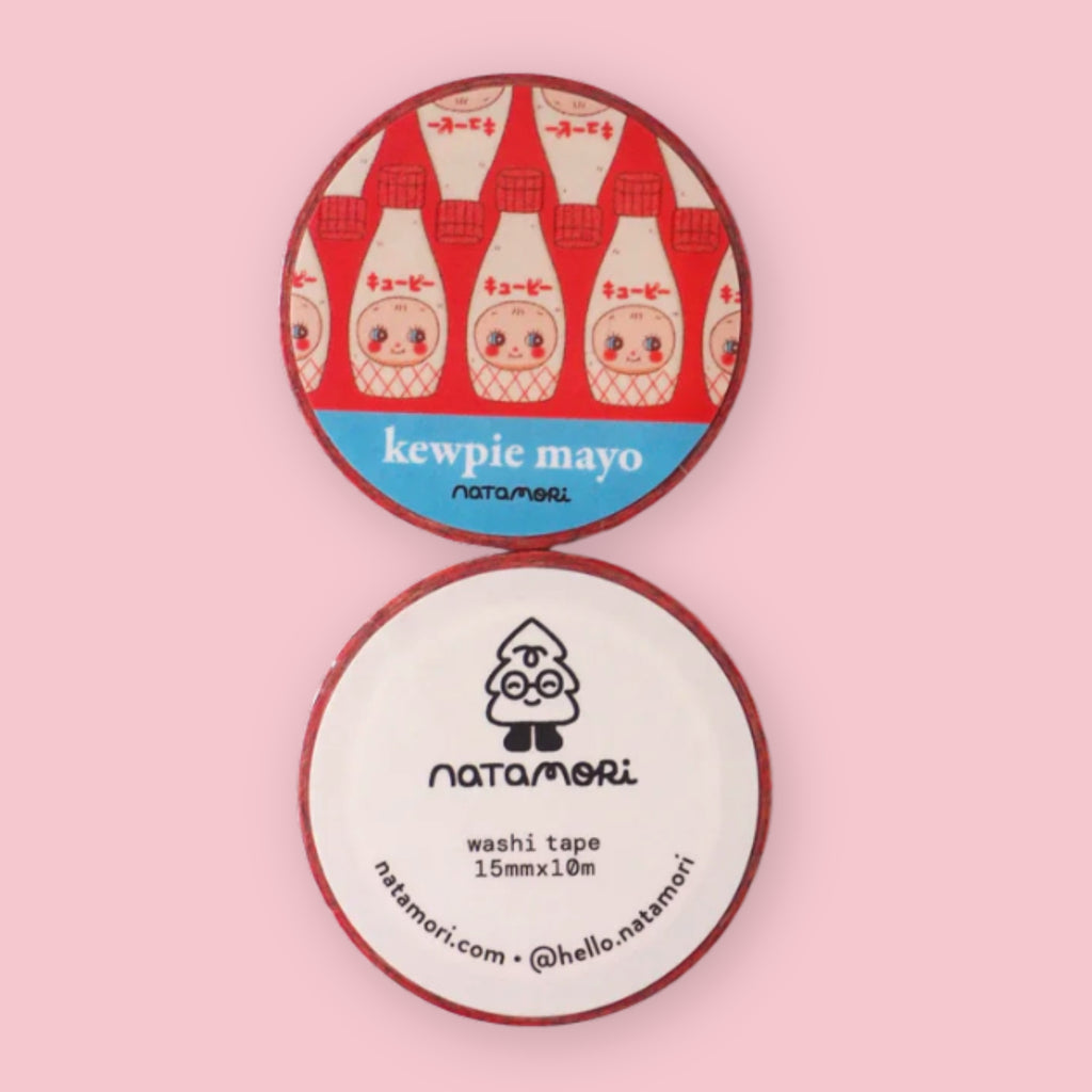 Two rolls of Natamori Kewpie Mayo washi tape stacked on a pink background, the top roll printed with rows of Kewpie mayonnaise bottles and "kewpie mayo natamori" label, the bottom roll showing the natamori logo and "washi tape 15mm x 10m" packaging label