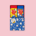 Plus Air-In Mt. Fuji Eraser two-pack in Hello Kitty and Dear Daniel limited edition Sanrio foil-stamped packaging, showing individual eraser boxes in yellow and blue with character illustrations and outer display box on a pink background