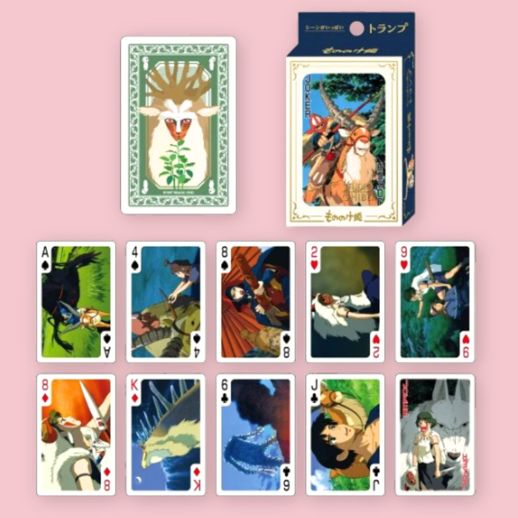 Studio Ghibli Princess Mononoke playing cards with card box and a card back design featuring a forest spirit, shown alongside an assortment of face cards illustrated with scenes and characters from the film, against a pink background