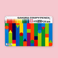 Sakura Coupy-Pencil set of 24 in a flat metal tin with colorful geometric block pattern design on a pink background
