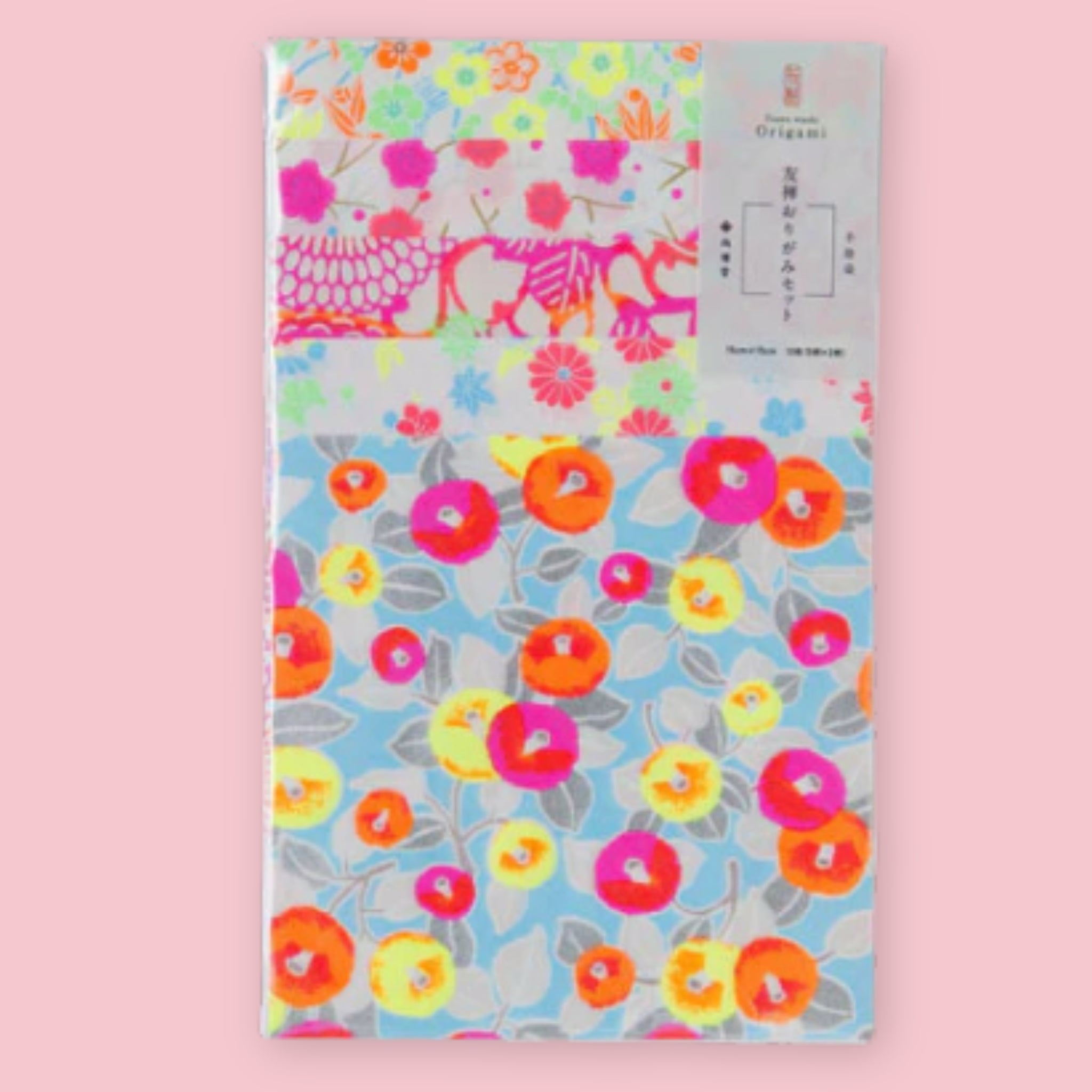 Shogado Yuzen Washi Origami Neon paper in its packaging, showing four neon floral patterns in pink, orange, yellow, and blue, against a pink background