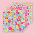 Five Shogado Yuzen Washi Origami Neon paper sheets fanned out showing different floral patterns in neon pink, orange, yellow, blue, and green, against a pink background