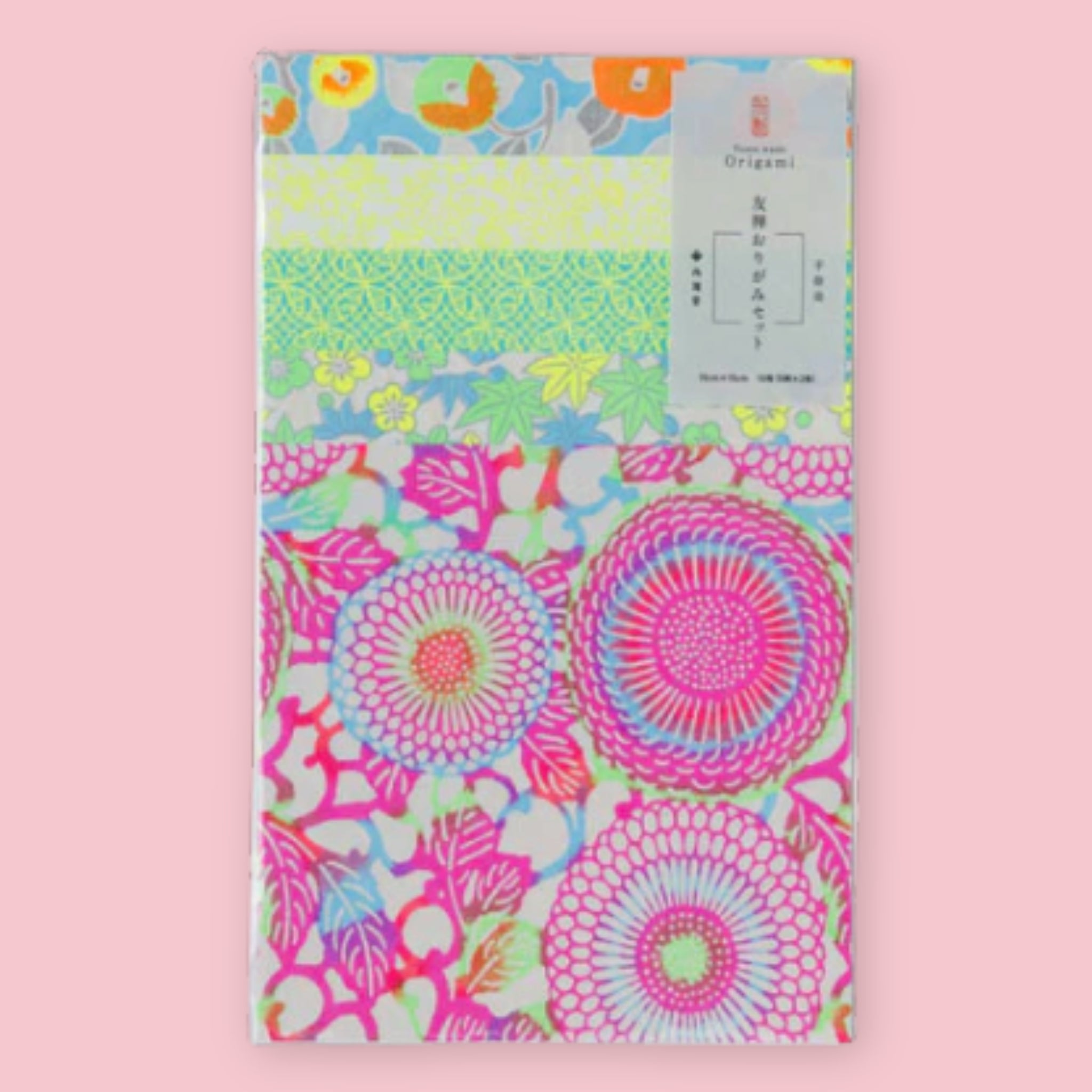 Shogado Yuzen Washi Origami Neon paper in its packaging, showing four neon floral patterns in pink, green, yellow, and blue, against a pink background