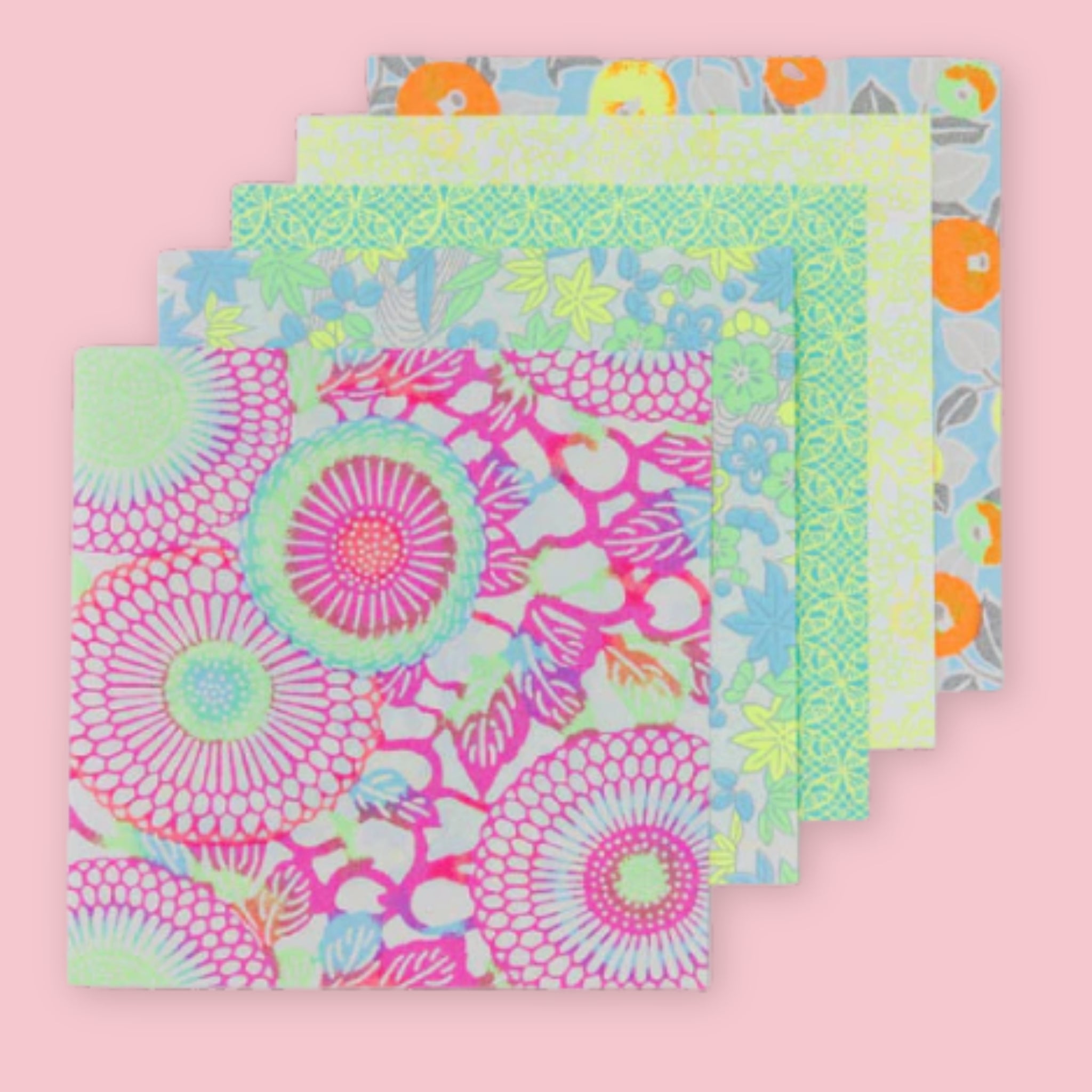 Five Shogado Yuzen Washi Origami Neon paper sheets fanned out showing different floral patterns in neon pink, orange, yellow, blue, and green, against a pink background